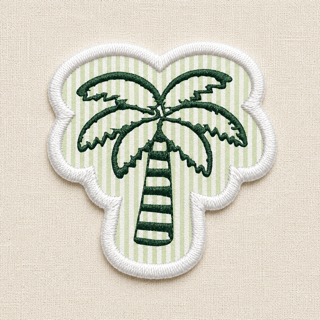 A close-up of an embroidered patch. In the center is a detailed green palm tree, set against a background of alternating horizontal stripes in a seersucker pattern. The entire patch is enclosed by a clean, raised white merrowed border.