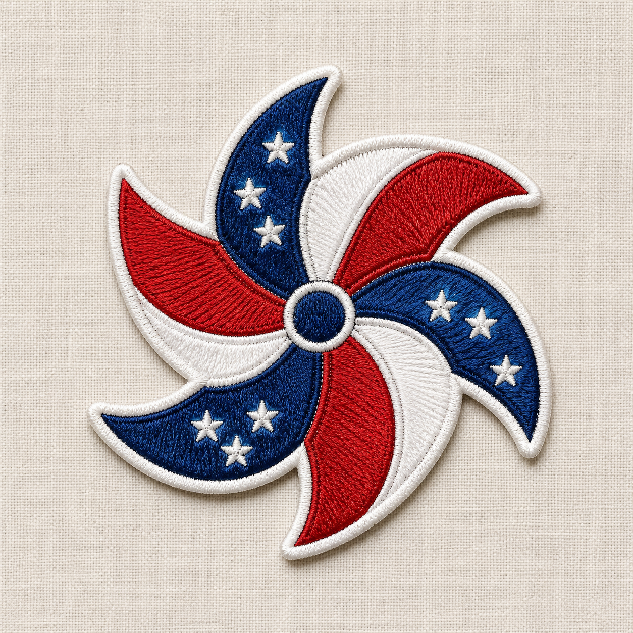 This is an embroidered patch of a pinwheel with red, white, and blue design on a beige background. Great for 4th of July or Americana themes! 

Decorative patch with red, white, and blue colors on a beige fabric background