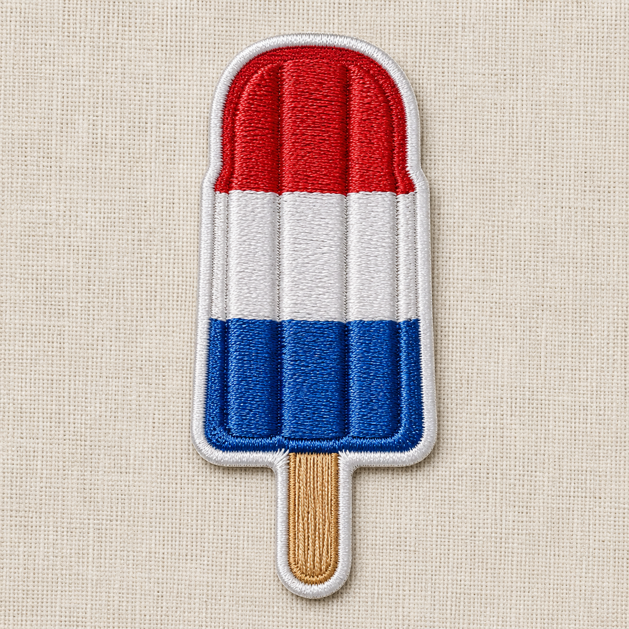 Embroidered patch of a red, white, and blue popsicle on a beige fabric background

Great for Summer, BBQ, Cookout, 4th of July or Americana themes! 