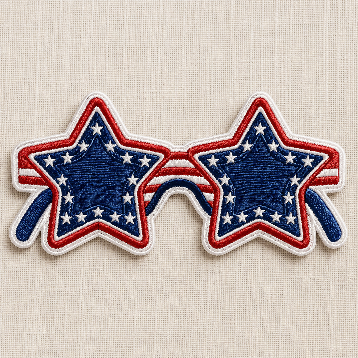 This is an embroidered patch of star-shaped sunglasses with red, white, and blue design on a beige background. Great for 4th of July or Americana themes! 