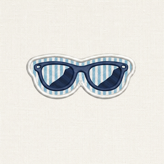 A close-up of a sunglass shaped embroidered patch. In the center is a detailed pair of sunglasses, set against a background of alternating horizontal stripes similar to seersucker. The entire patch is enclosed by a clean, raised white merrowed border.